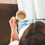 Woman reading Bible with coffee, symbolizing healing in divorce recovery program.