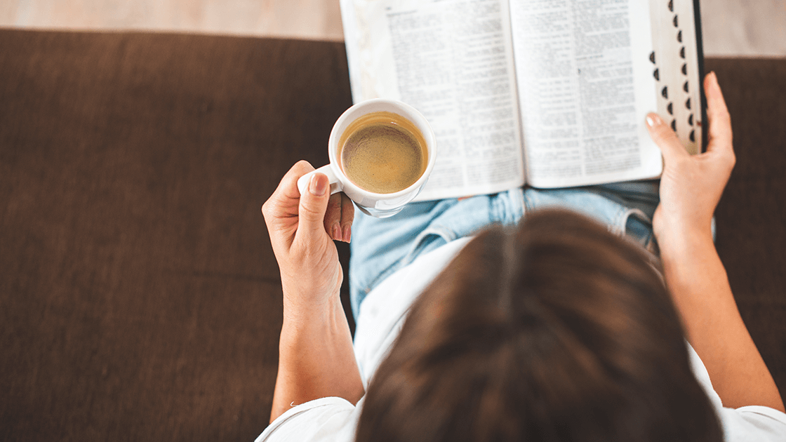 Woman reading Bible with coffee, symbolizing healing in divorce recovery program.